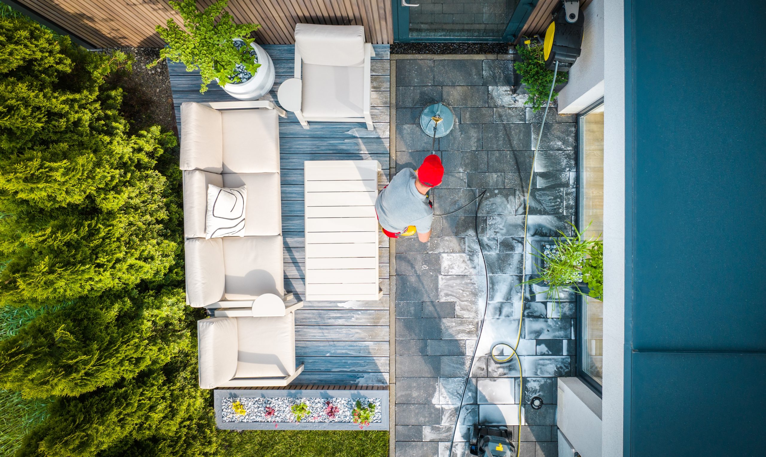 Top,View,Of,Caucasian,Home,Owner,Washing,The,Walkway,At